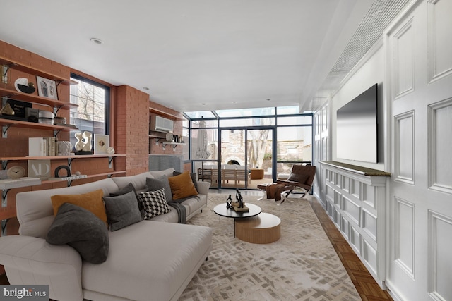 living room with a wall of windows and a wall mounted AC