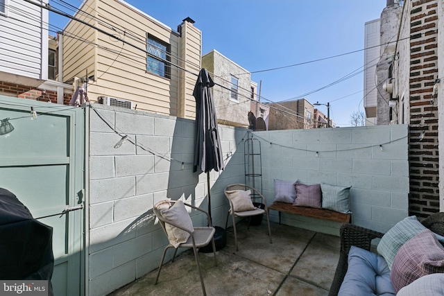 view of patio / terrace featuring fence