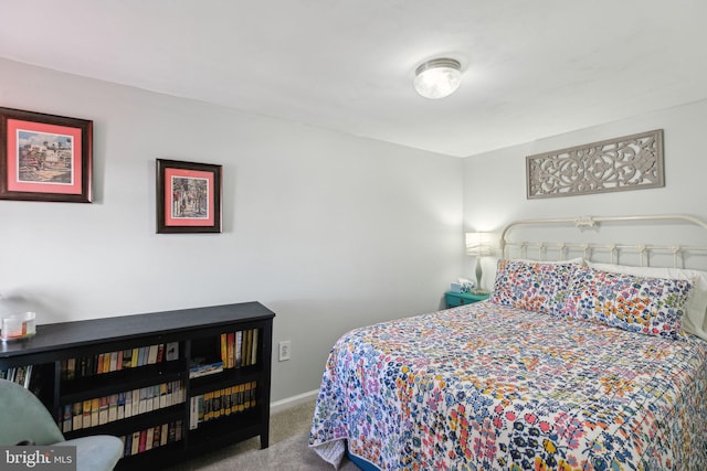 carpeted bedroom featuring baseboards