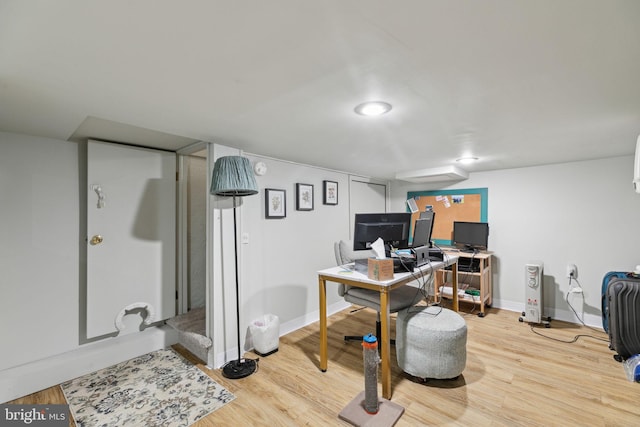 office space featuring baseboards and wood finished floors