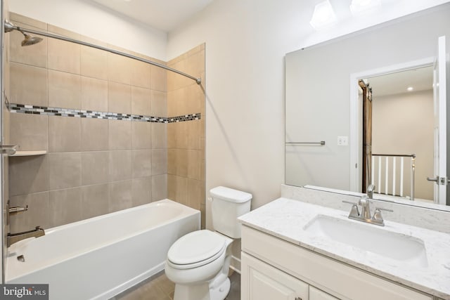 bathroom featuring shower / bath combination, toilet, and vanity