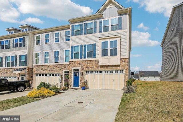 view of property featuring driveway, an attached garage, a front lawn, stone siding, and board and batten siding