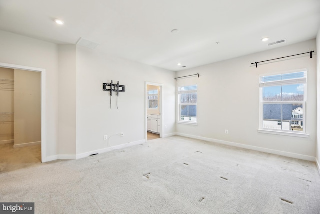 unfurnished bedroom featuring recessed lighting, visible vents, carpet flooring, and baseboards