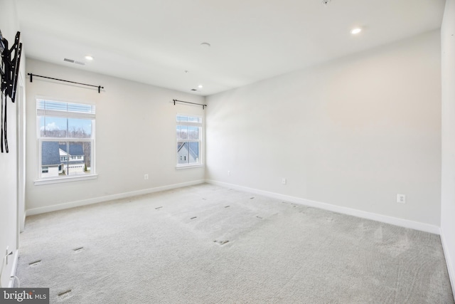 unfurnished room featuring recessed lighting, visible vents, carpet flooring, and baseboards