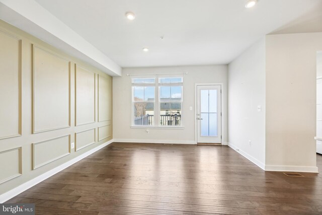 unfurnished room with recessed lighting, visible vents, baseboards, and dark wood-style flooring