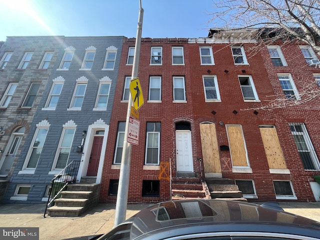 view of property with brick siding and entry steps