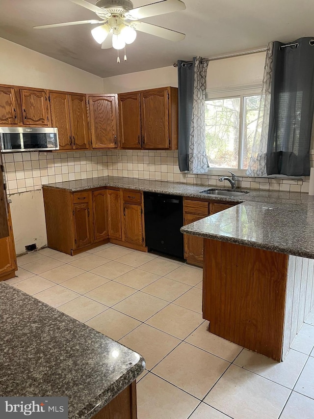 kitchen featuring brown cabinetry, a peninsula, black dishwasher, and a sink