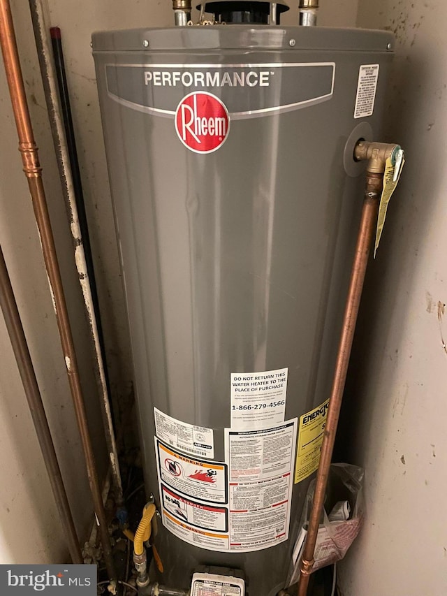 utility room featuring water heater