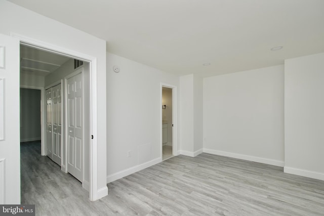 unfurnished room with visible vents, baseboards, and light wood-type flooring