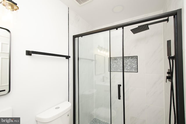 bathroom with visible vents, a stall shower, and toilet