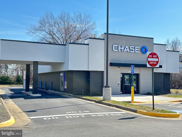 view of building exterior featuring uncovered parking