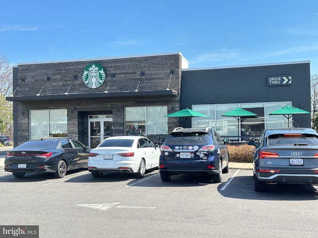 view of building exterior featuring uncovered parking