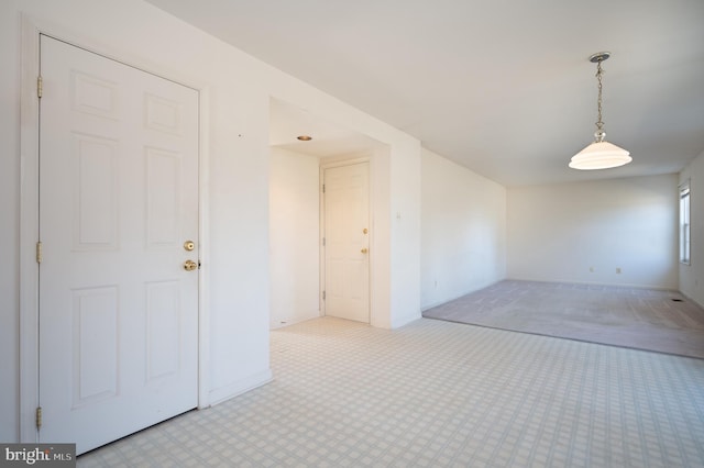 empty room featuring baseboards and carpet floors