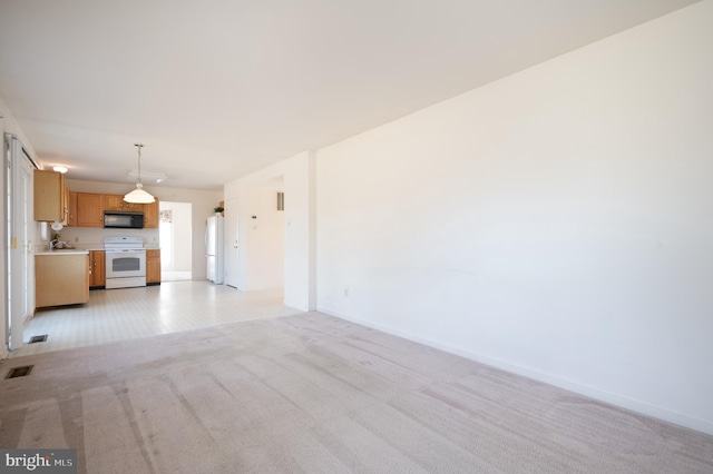 unfurnished living room featuring light carpet, baseboards, visible vents, and a sink