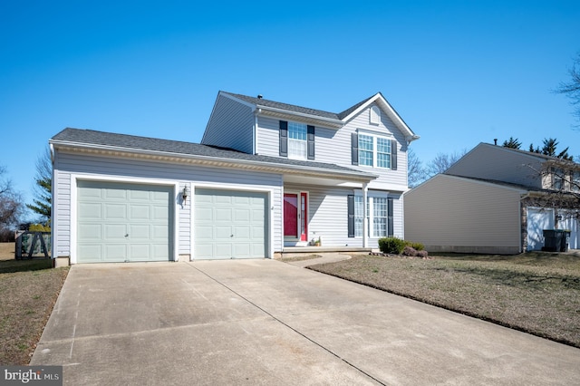 traditional home featuring a garage and concrete driveway