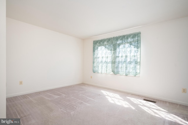 unfurnished room featuring visible vents, baseboards, and carpet floors