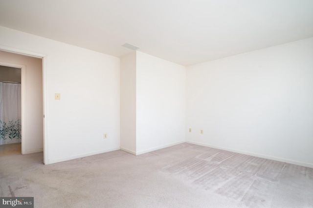 empty room with light carpet and baseboards