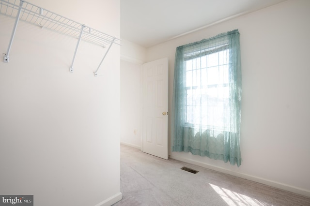 spacious closet with visible vents and carpet