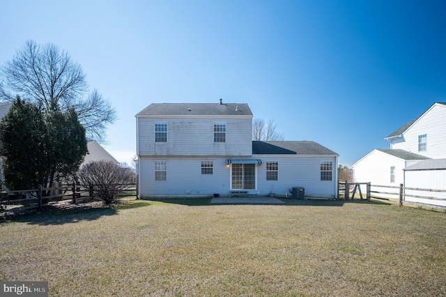 back of house featuring central air condition unit, a lawn, a fenced backyard, and a patio area