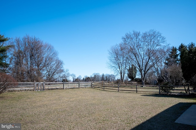 view of yard featuring a rural view and fence