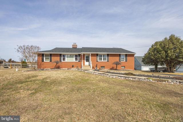 ranch-style home featuring a front yard, fence, a chimney, crawl space, and brick siding