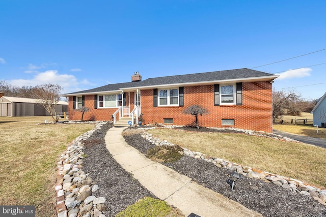 ranch-style home with a front yard, brick siding, roof with shingles, and a chimney