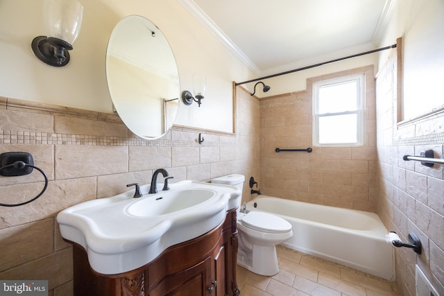 bathroom with tile walls, crown molding, toilet, bathing tub / shower combination, and vanity