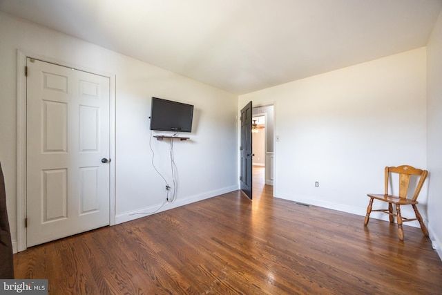 unfurnished bedroom with wood finished floors and baseboards