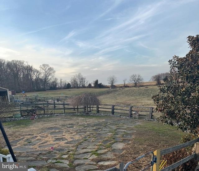 view of yard with a rural view and fence