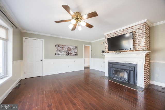 unfurnished living room featuring a glass covered fireplace, wood finished floors, and ornamental molding