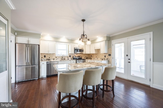 kitchen with stainless steel appliances, dark wood finished floors, french doors, and white cabinetry