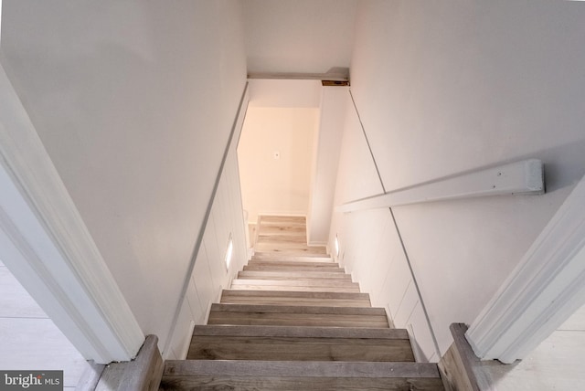 staircase with wood finished floors