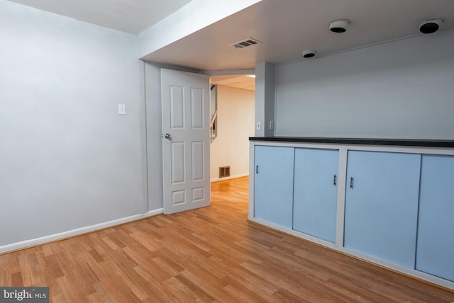 unfurnished room with visible vents, baseboards, and light wood-style floors