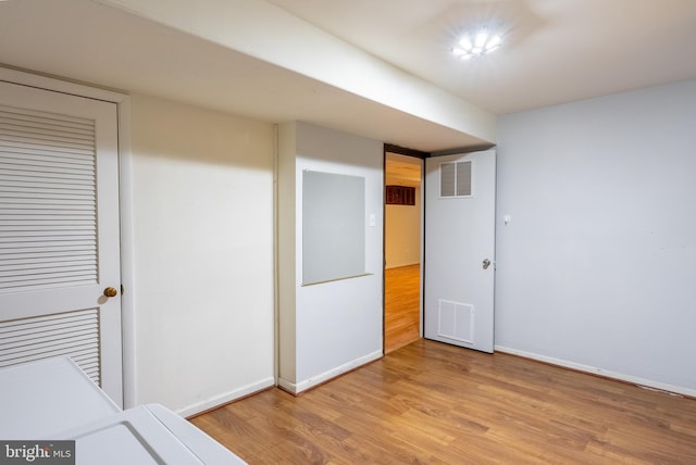 unfurnished bedroom featuring light wood-style flooring, baseboards, and visible vents