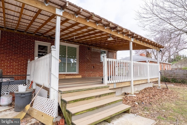 deck with a carport and fence