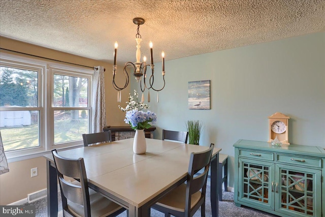 dining room featuring carpet flooring, visible vents, a chandelier, and a textured ceiling