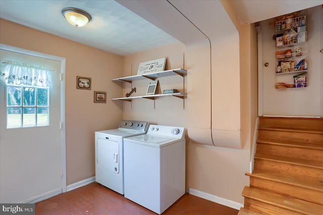 laundry room with brick floor, baseboards, independent washer and dryer, and laundry area