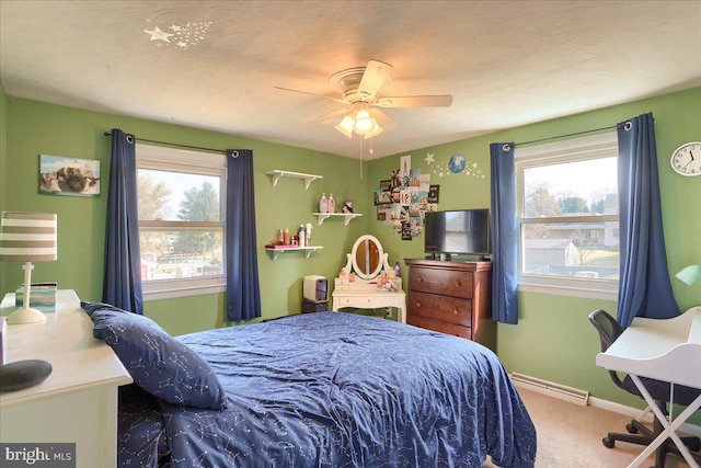 carpeted bedroom with a ceiling fan and baseboards