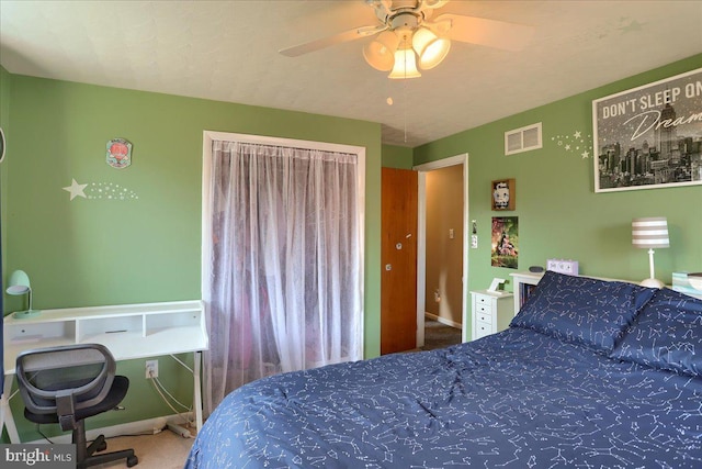 bedroom with baseboards, visible vents, a ceiling fan, and carpet