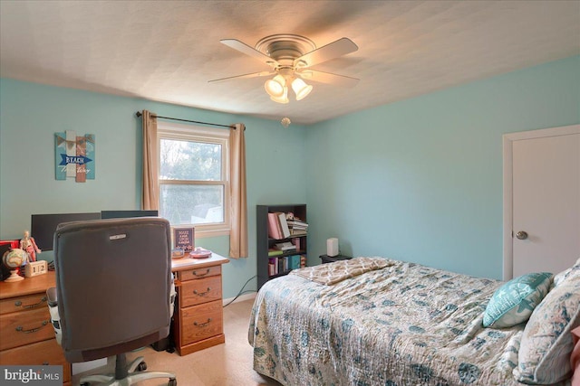 bedroom featuring light carpet and a ceiling fan