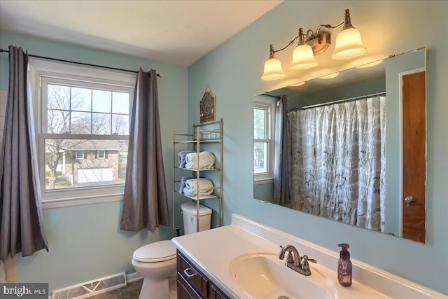 full bathroom with visible vents, plenty of natural light, toilet, and vanity