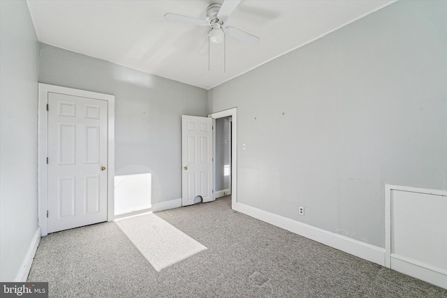 unfurnished bedroom featuring ceiling fan, baseboards, and carpet