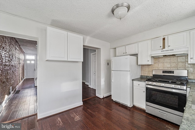 kitchen with dark wood-style floors, stainless steel gas range, freestanding refrigerator, white cabinets, and under cabinet range hood