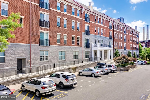 view of building exterior featuring uncovered parking