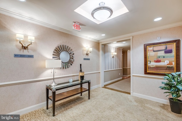 hall with baseboards, carpet, and crown molding