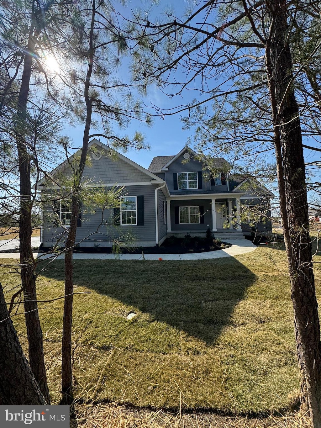 view of front of home with a porch and a front yard