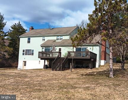 back of house with stairway and a deck