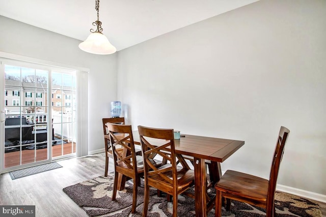 dining area with wood finished floors and baseboards