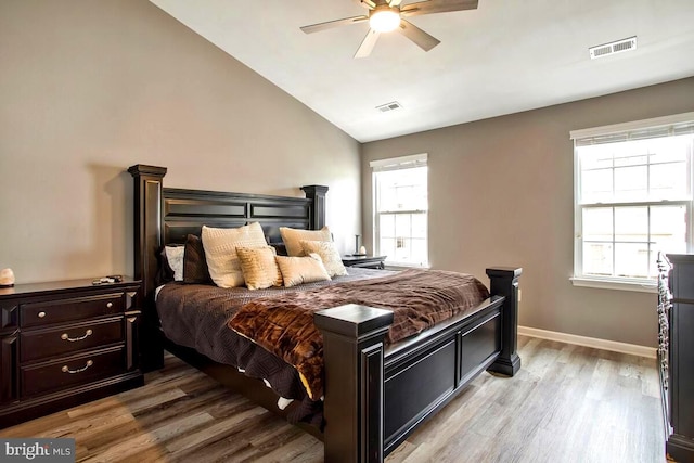 bedroom with visible vents, multiple windows, and light wood-style floors