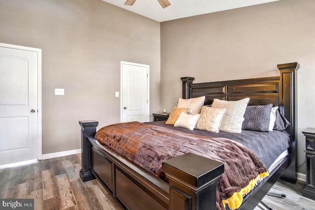 bedroom featuring baseboards, wood finished floors, and a ceiling fan